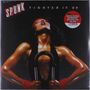 Oben steht "SPUNK TIGHTEN IT UP". Ein muskulöser Mensch hebt den Kopf, mit roten Schweißbändern und einem Fitnessgerät., LP