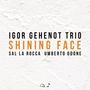 IGOR GEHENOT TRIO, SHINING FACE, SAL LA ROCCA, UMBERTO ODONE; schwarzer und oranger Text auf strukturiertem weißen Hintergrund., CD