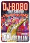 DJ BOBO, The Show, Dancing Las Vegas, LIVE IN BERLIN. Ein lächelnder Mann im goldenen Anzug zeigt auf etwas., 1 DVD und 1 CD