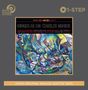 „Mingus Ah Um / Charles Mingus“ und Trackliste in stilisiertem Text. Künstlerisches, abstraktes Gemälde in lebhaften Farben.