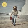 Der Text lautet: "The Wellermen 'Homeward Bound'". Eine Person mit Taucherhelm und Koffer geht am Strand entlang.