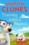 Text: "MARTIN CLUNES Training John & Murray"  
Illustration: Zwei Hunde, einer mit Brille, eine ländliche Szene im Hintergrund., Buch