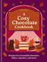 Titel: "A Cosy Chocolate Cookbook". Untertitel: "Recipes for irresistible brownies, bakes, cupcakes, and more". Illustration zeigt eine Tasse Kakao, Bücher, Katze und Gebäck auf lila Hintergrund., Buch