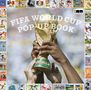 „FIFA World Cup Pop-Up Book“ in großen Buchstaben über der berühmten Goldtrophäe, umgeben von Briefmarken., Buch