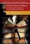 "Social Science History" zeigt ein offenes Buch auf einem Stapel alter Bücher, darunter eine Lupe., Buch