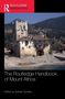 Text: "The Routledge Handbook of Mount Athos. Edited by Graham Speake." Ruinenartiges Gebäude vor bewaldetem Hügel., Buch