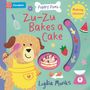 "Zu-Zu Bakes a Cake" steht in roten Buchstaben. Ein Hund in Schürze hält einen Löffel, daneben Kuchen, Erdbeere, Wassermelone., Buch