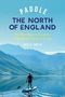 "Paddle The North of England" Buchcover. Frau paddelt auf See, umgeben von Bergen und Bäumen unter blauem Himmel., Buch