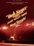 Text: "Bob Seger & The Silver Bullet Band Nine Tonight". Bühne mit Schlagzeug, Scheinwerfer strahlen nach unten., Noten