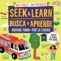 Text: "My First • Mi Primer", "Seek & Learn • Busca y Aprende", "Around Town • Por la Ciudad", "English & Spanish First Words". Illustration mit Feuerwehrauto, Baum, Hunden und Gegenständen.