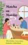 "Matcha on Monday" von Michiko Aoyama. Zwei Personen sitzen beim Tee an einem runden Tisch, eine Katze rechts., Buch