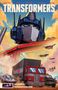 TRANSFORMERS, Volume 5, Generation One. Ein großer Roboterkopf dominiert die Szene, umgeben von Fahrzeugen und Flugzeugen., Buch