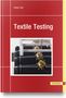 „Textile Testing“ von Dieter Veit. Rotes Cover, Bild von Maschinen mit Ketten und stacheligen Kugeln., Buch