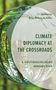 Text: "Climate Diplomacy at the Crossroads" und "A Multidisciplinary Perspective". Baumreflexion in einer Glaskugel., Buch