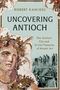 Text: "Robert Kanigel: Uncovering Antioch. The Ancient City and Its Lost Treasures of Mosaic Art." 
Mosaik und Ausgrabungsszene., Buch