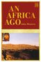 Text: "An Africa Ago" und "John Western". Eine Landschaft mit Zug und Schienen vor einem Berg, oben rechts "JB" Logo., Buch