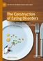 „The Construction of Eating Disorders“. Teller mit wenigen Erbsen und Gemüse, Person kehrt Erbsen., Buch