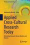 Buchtitel: "Applied Cross-Cultural Research Today". Autorenname: Adebowale Akande. Hintergrund in Gelb mit abstraktem Muster., Buch
