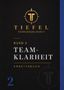 "TIEFEL FÜHRUNGSKLARHEIT, Band 2 TEAMKLARHEIT, ARBEITSBUCH" - Goldenes Logo mit T auf schwarzem Hintergrund., Buch