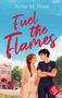 Der Text lautet: "Annie M. Rose, Fuel the Flames". Zwei Personen stehen lächelnd nebeneinander vor einer Feuerwache., Buch