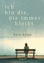 „Ich bin die, die immer bleibt“, Enia Arlen, Roman. Eine Person sitzt auf einer Bank vor einem ruhigen See., Buch