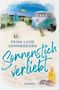Text: "FRIDA LUISE SOMMERKORN Sonnenstich Verliebt ROMAN". Illustration: Strand mit Camper, Zelte, "CAMP"-Fahne, Sonnenbrille., Buch