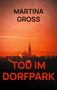 Text: "MARTINA GROSS", "TOD IM DORFPARK". Silhouette einer Stadt mit Kirchturm im roten Himmel., Buch