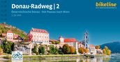 Text: "Donau-Radweg | 2. Österreichische Donau · Von Passau nach Wien. 1:50.000. bikeline DIE RADTOURENPROFIS. AUCH FÜR E-BIKES."

Eine malerische Flusslandschaft mit historischen Gebäuden am Ufer., Buch