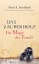 „Das Zauberholz: Die Magie des Tanuki“. Beigefarbener Hintergrund mit einer kleinen Statue eines Tieres unten rechts., Buch