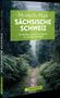 „Mystische Pfade Sächsische Schweiz“ von Christiane Hube. Ein bewaldeter Pfad, umgeben von üppigem Grün., Buch