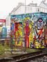 Reinhard Matz, Köln. Wunderlich, emons:. Bunt bemaltes Gebäude mit Graffiti-Figuren vor Häusern und Bahngleisen., Buch