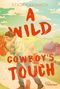 „A Wild Cowboy's Touch“ von Stacey Kennedy. Illustration: Paar küsst sich auf einem Weg, Scheune im Hintergrund., Buch