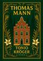 “THOMAS MANN" und "TONIO KRÖGER" in Gelb. Illustration eines roten Hauses mit gelbem Rahmen, Floralmuster und grüner Kulisse., Buch