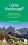 Leichte Wanderungen Südtirol. Malerische Berge mit grünen Feldern und einem Dorf im Vordergrund. ROTHER-Logo links.
