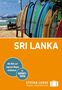 "SRI LANKA" in großen Buchstaben auf orangem Hintergrund. Surfboards am Strand, ein blauer Sonnenschirm, Palmen im Hintergrund., Buch