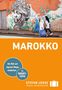 Text "MAROKKO". Darunter gehen verschleierte Frauen vor einer Wand mit großem Gesichtsgraffiti. Hinweis auf Reisehandbuch., Buch