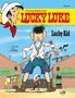 Text: "Lucky Luke", "Lucky Kid", "Band 89", "SCHULE", "SALOON". Illustration: Cowboy mit Halstuch, kleiner Junge mit Revolver., Buch