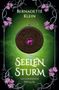 "Seelensturm: Seelenbande Prequel" von Bernadette Klein. Mystisches Medaillon mit violettem Edelstein und floralem Rahmen., Buch
