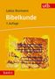 Text: "Lukas Bormann Bibelkunde 7. Auflage utb basics". Gelber Hintergrund, antiker Text auf Papyrus-Stil Dokument., Buch