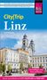 Reiseführer „City|Trip Linz“ von Sven Eisermann. Bild zeigt historische Gebäude und Kirche bei blauem Himmel., Buch