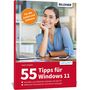 Text: "Für die Arbeit und Zuhause", "55 Tipps für Windows 11", "BILDNER". Frau sitzt lächelnd an einem Schreibtisch., Buch