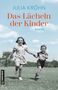 "Julia Kröhn, Das Lächeln der Kinder, Roman. Eine Geschichte über tiefe Wunden – und ihre Heilung." Zwei Kinder rennen glücklich., Buch