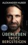 Text: "ALEXANDER HUBER", "ÜBERLEBEN TROTZ BERGSTEIGEN", "MALIK". Nahaufnahme eines Mannes mit Bart vor schwarzem Hintergrund., Buch