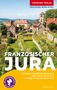 Titel: "Französischer Jura". Bild: Malerische Dorfansicht mit historischen Gebäuden und hügeliger Landschaft.