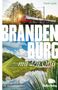 Text: "BRANDENBURG mit den Öffis", "Ausflugsziele für Klimabewusste", "BeBra Verlag". Zug vor Sonnenuntergang, See., Buch