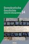"26. September – 29. Dezember 1944: 2500 Zwangsarbeiter aus dem KZ Husum; mehr als 300 verlieren Leben." Text auf Kopfsteinpflaster., Buch