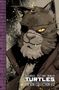Text: "TEENAGE MUTANT NINJA TURTLES THE IDW COLLECTION V12". Illustration einer katzenartigen Figur mit Augenklappe.