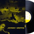 Text: „JOHNNY GRIFFIN“ und beschreibt eine Schallplatte vor einem Cover mit fliegenden Vögeln und einem Saxophonspieler.