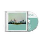 CD-Hülle und CD mit "Cory Wong and the Green Screen Band". Moderne Stadtansicht, Person mit Gitarre in der Mitte.