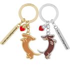 Schlüsselanhänger mit Text "DU BIST MEIN Lieblingsmensch" und Hundemotiv in Gold und Silber, mit einem kleinen roten Herz.